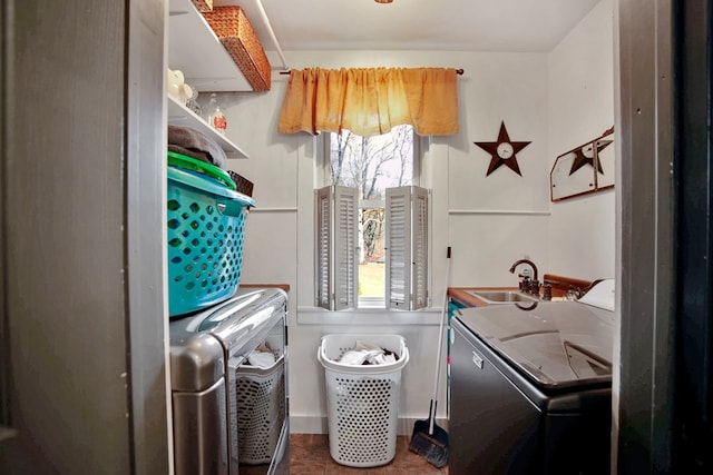 laundry room with washing machine and dryer, laundry area, and a sink