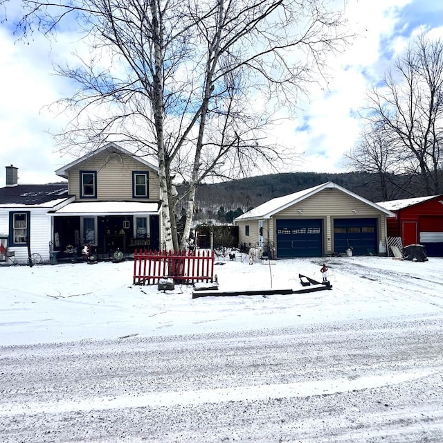 view of front of home featuring a garage and an outdoor structure