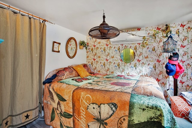 bedroom featuring a wall unit AC and wallpapered walls