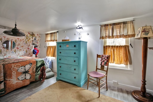 bedroom featuring baseboards and wood finished floors