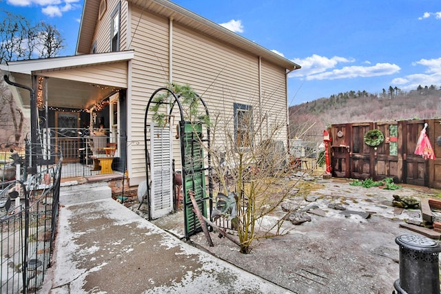 view of side of home featuring fence