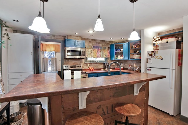 kitchen featuring appliances with stainless steel finishes, dark countertops, backsplash, and blue cabinets