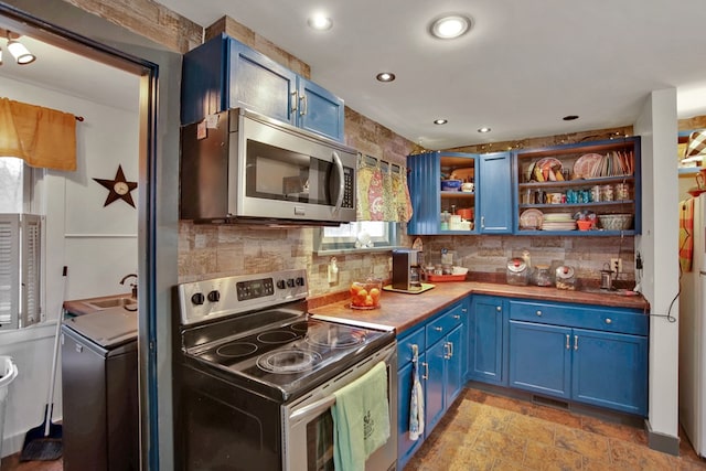 kitchen featuring blue cabinets, tasteful backsplash, and appliances with stainless steel finishes