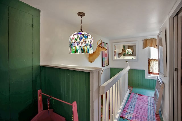 interior space featuring a wainscoted wall and wood walls