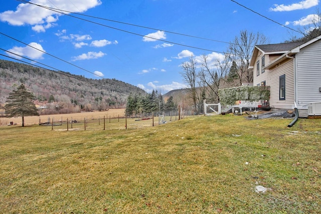 view of yard with a mountain view and fence