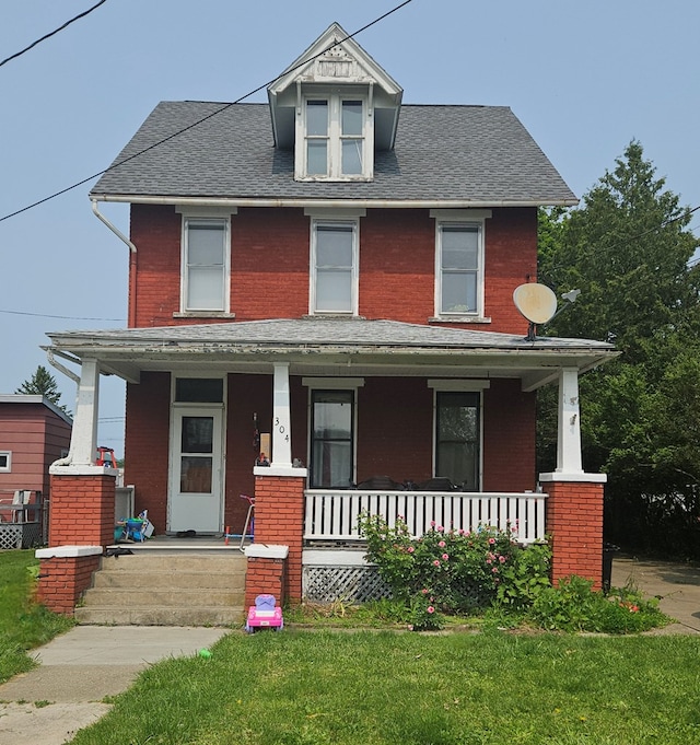 304 N Elmer Ave, Sayre, PA 18840 - american foursquare style home with a porch, brick siding, a front lawn, and a shingled roof