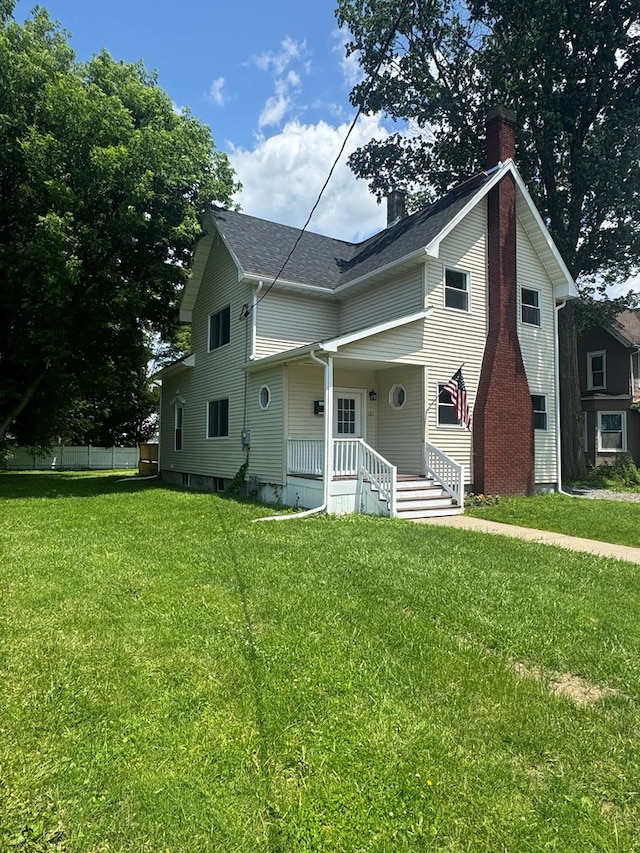 121 Park Pl, Waverly, NY 14892 - view of front of home with a chimney, a porch, a front yard, and a shingled roof