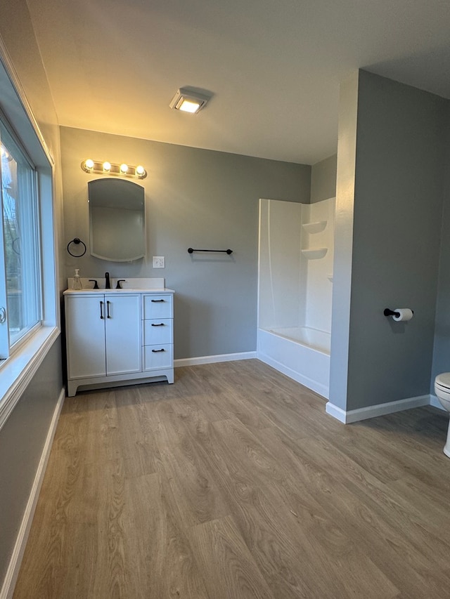 121 Park Pl, Waverly, NY 14892 - bathroom featuring wood finished floors, vanity, and tub / shower combination