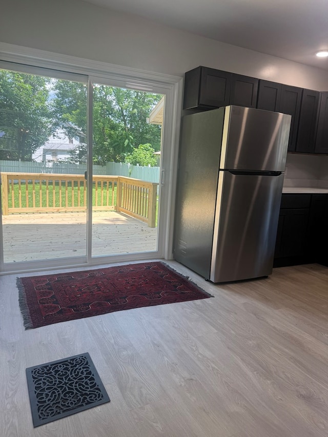 121 Park Pl, Waverly, NY 14892 - kitchen featuring freestanding refrigerator, light wood-type flooring, and dark cabinets