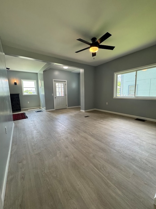 121 Park Pl, Waverly, NY 14892 - unfurnished living room with wood finished floors, plenty of natural light, and a ceiling fan