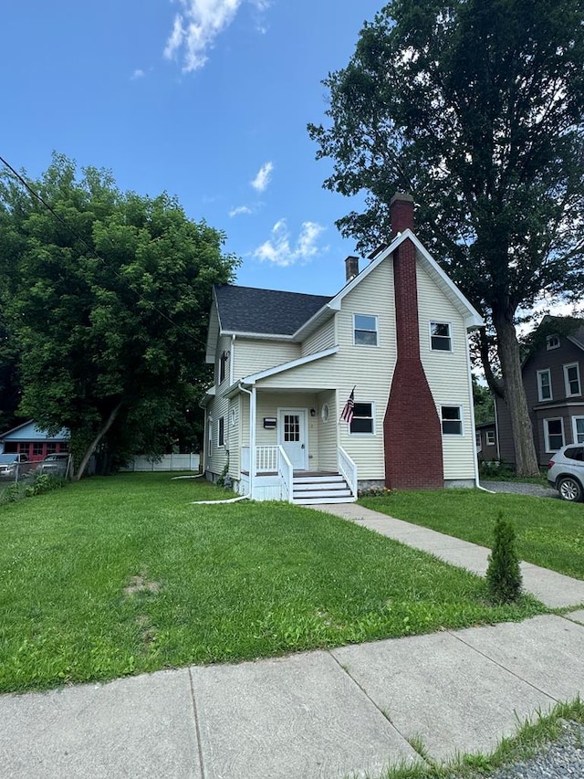 121 Park Pl, Waverly, NY 14892 - view of front of property featuring a chimney, a front yard, and covered porch