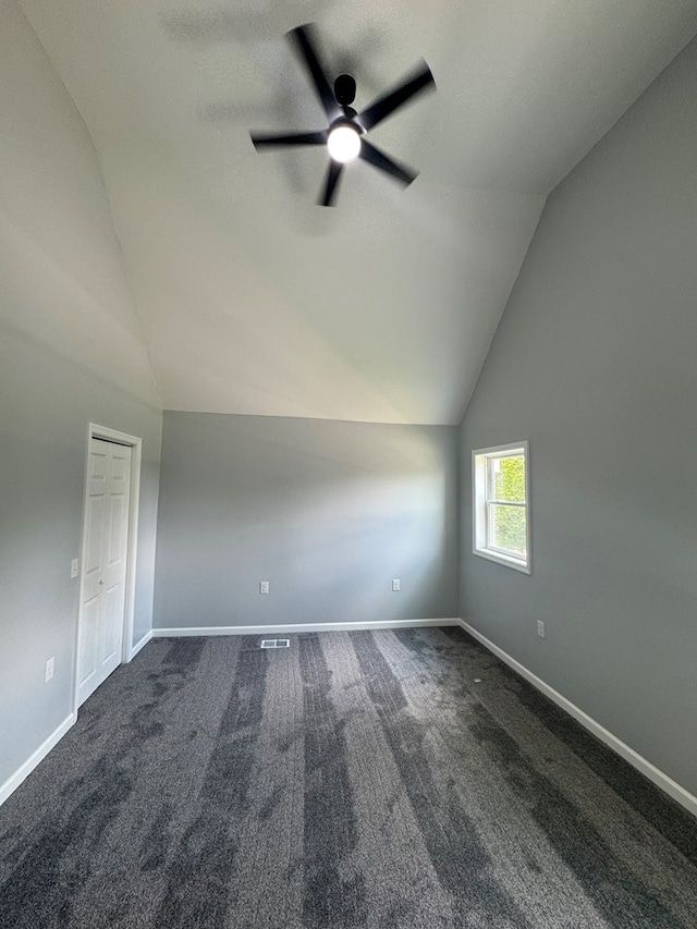 121 Park Pl, Waverly, NY 14892 - spare room with lofted ceiling, a ceiling fan, and dark carpet