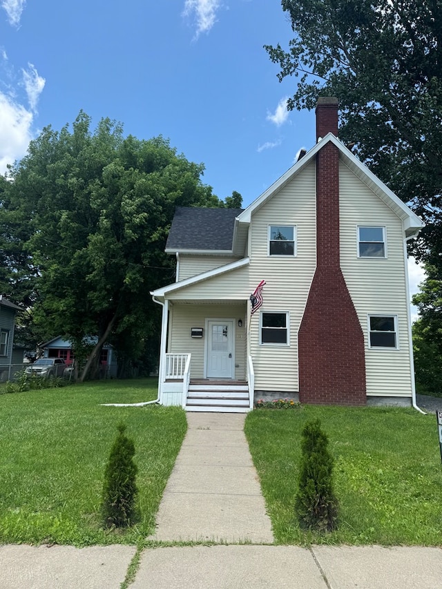 121 Park Pl, Waverly, NY 14892 - view of front of home featuring a chimney, a front yard, a porch, and a shingled roof