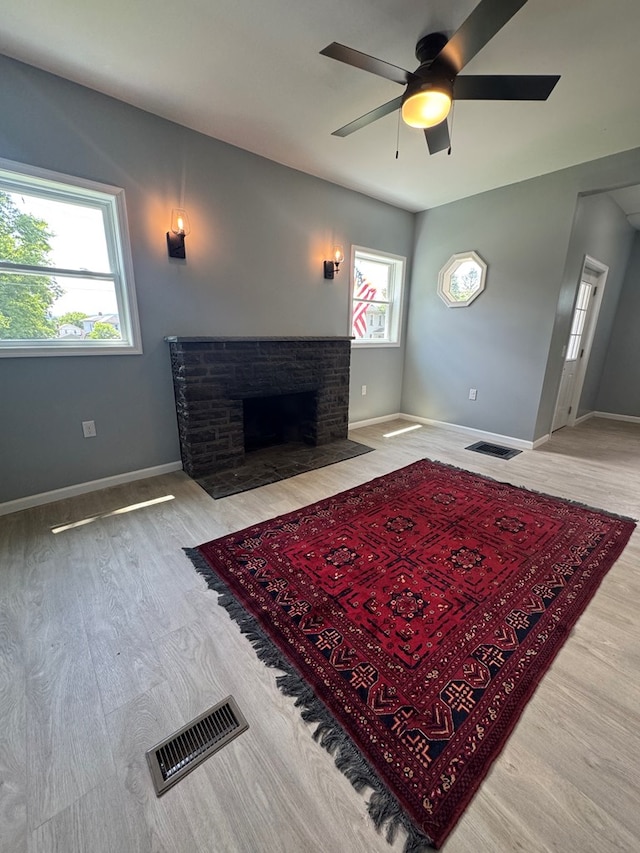 121 Park Pl, Waverly, NY 14892 - living room featuring wood finished floors, ceiling fan, and a fireplace with flush hearth