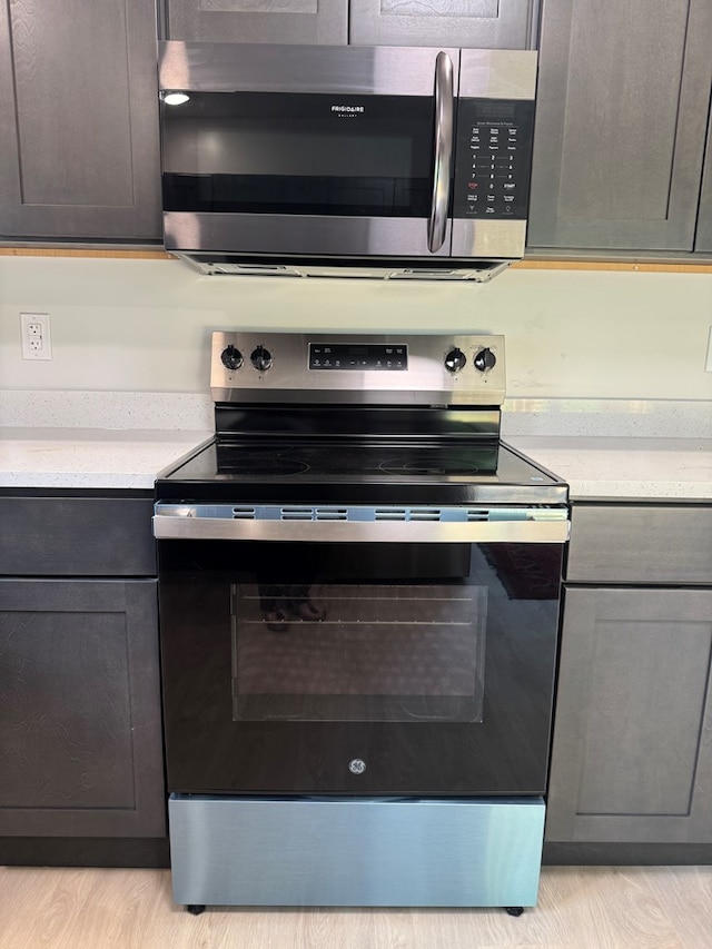 121 Park Pl, Waverly, NY 14892 - kitchen with appliances with stainless steel finishes, light countertops, and light wood-type flooring