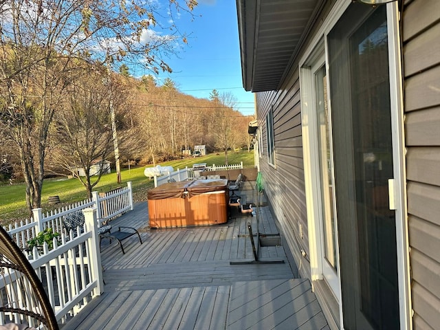 wooden deck with a hot tub