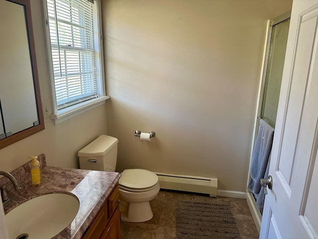 bathroom with toilet, vanity, and a baseboard heating unit