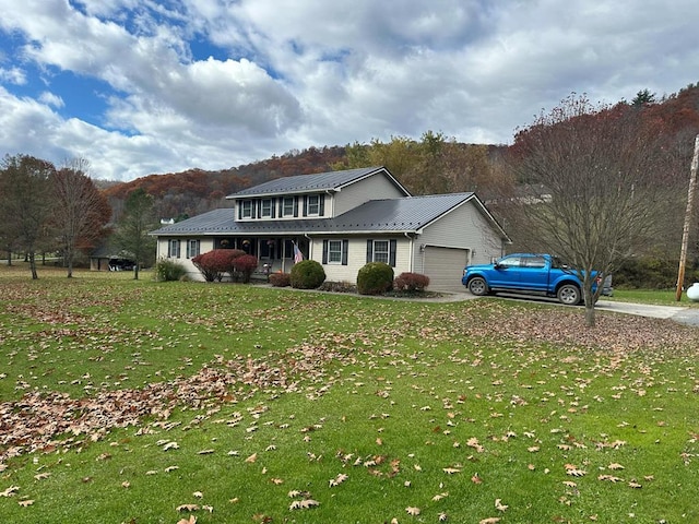 view of front of home featuring a porch, a garage, and a front lawn