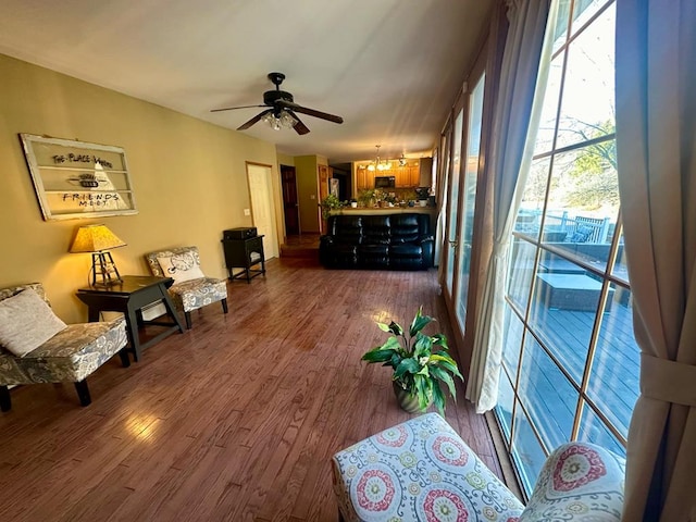 sitting room featuring ceiling fan and dark wood-type flooring