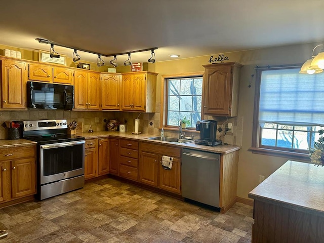 kitchen with sink, stainless steel appliances, and tasteful backsplash