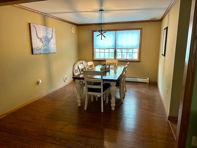 dining room featuring dark hardwood / wood-style flooring, ornamental molding, and a baseboard heating unit