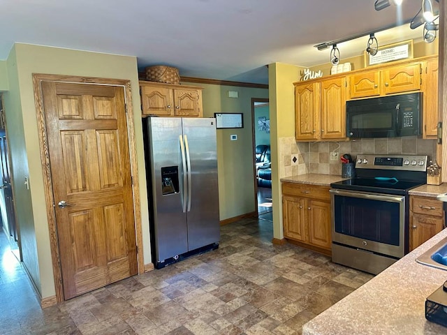 kitchen with appliances with stainless steel finishes, backsplash, and ornamental molding