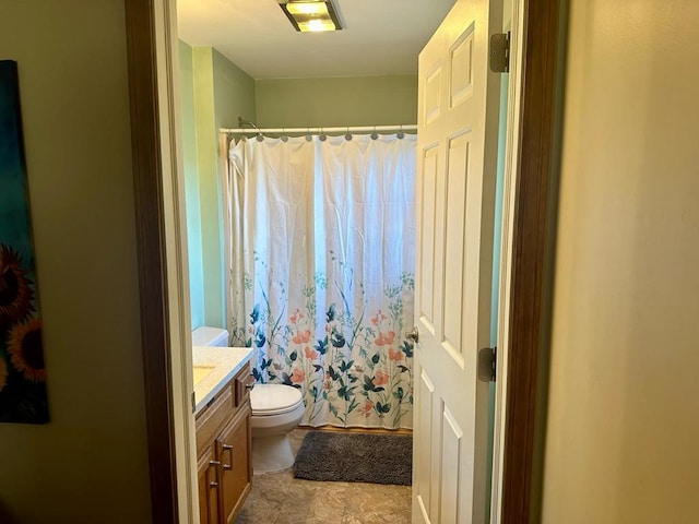 bathroom with vanity, toilet, and walk in shower