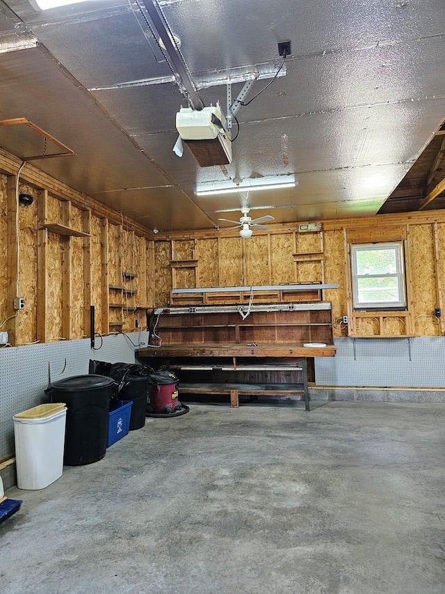 garage with a garage door opener and a workshop area