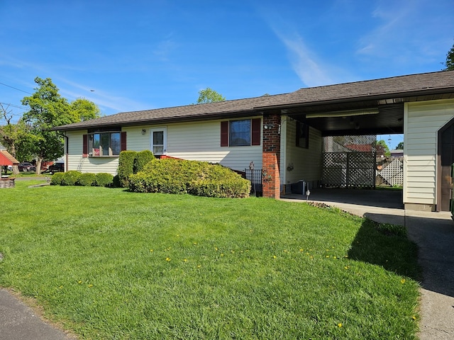 view of front of property with a front yard and a carport
