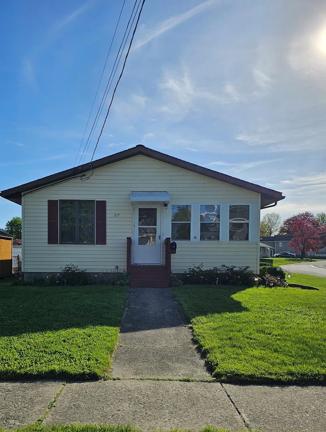 bungalow-style home featuring a front yard