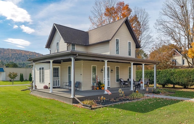 view of front of home with covered porch and a front yard