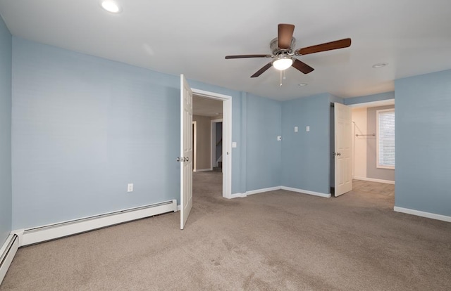 unfurnished bedroom with ceiling fan, light colored carpet, and baseboard heating