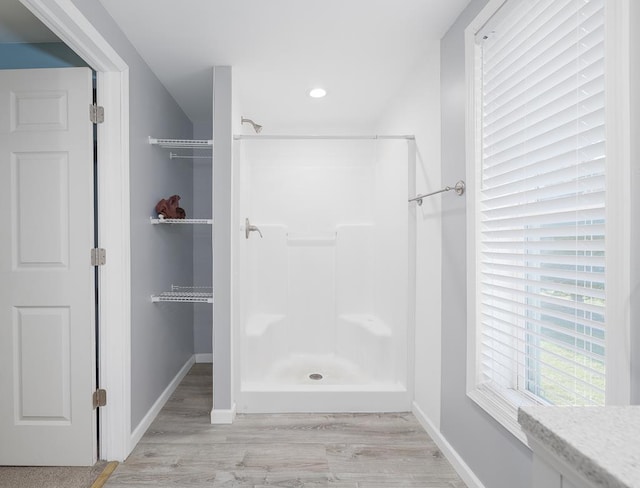 bathroom featuring a shower and wood-type flooring