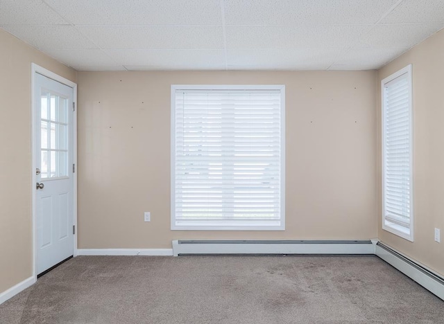 carpeted spare room featuring a baseboard radiator