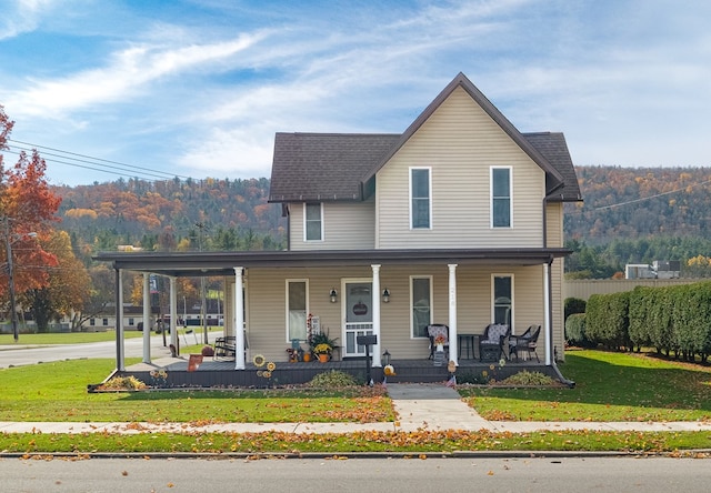 view of front facade with covered porch and a front lawn