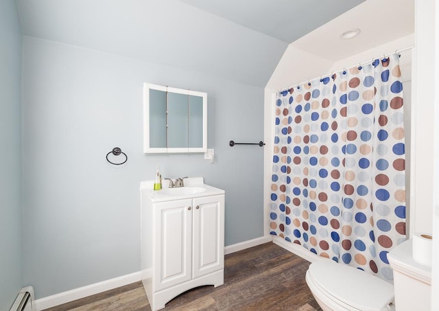 bathroom featuring vanity, hardwood / wood-style flooring, toilet, and baseboard heating