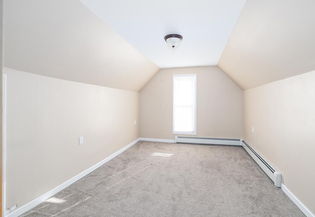 bonus room featuring light colored carpet, a baseboard radiator, and lofted ceiling