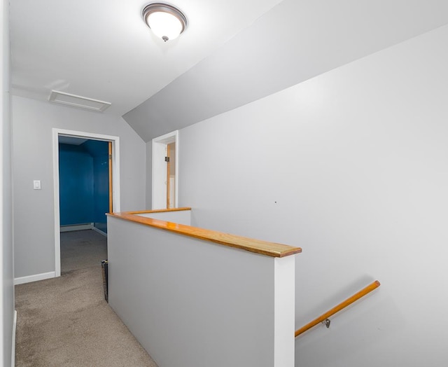 corridor featuring light colored carpet, lofted ceiling, and a baseboard heating unit