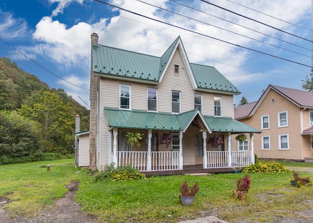 view of front of house featuring a front yard and a porch