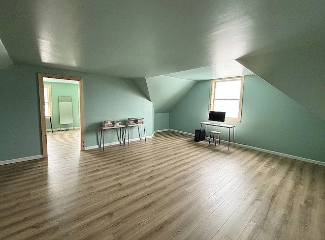 bonus room featuring hardwood / wood-style flooring and vaulted ceiling