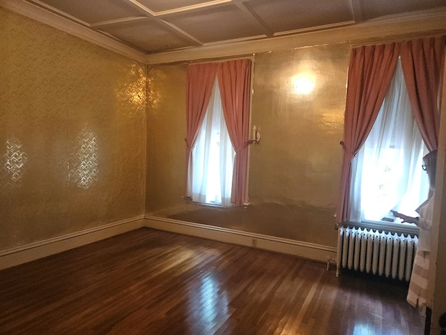 446 Pennsylvania Ave, Waverly, NY 14892 - empty room featuring radiator heating unit, wood finished floors, coffered ceiling, and ornamental molding
