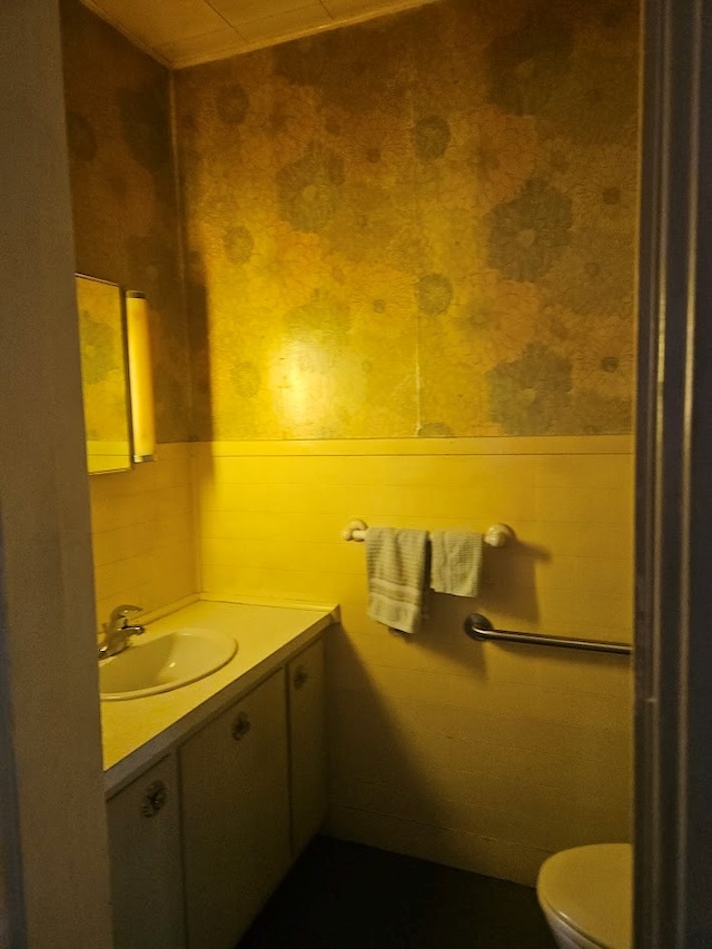 446 Pennsylvania Ave, Waverly, NY 14892 - half bath with wallpapered walls, vanity, and a wainscoted wall