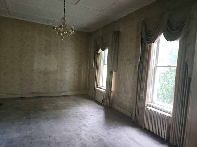 446 Pennsylvania Ave, Waverly, NY 14892 - spare room with unfinished concrete floors, a chandelier, and radiator