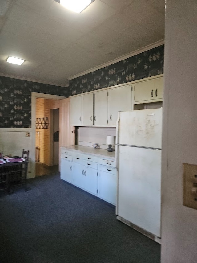 446 Pennsylvania Ave, Waverly, NY 14892 - kitchen featuring freestanding refrigerator, wallpapered walls, crown molding, a wainscoted wall, and white cabinetry