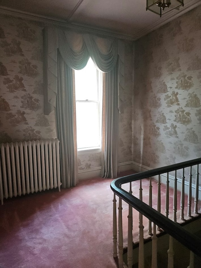446 Pennsylvania Ave, Waverly, NY 14892 - empty room featuring radiator heating unit, carpet floors, wallpapered walls, and crown molding