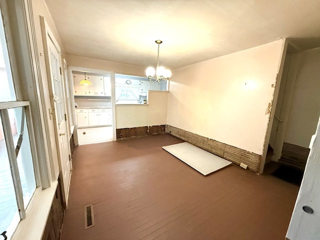 interior space with hardwood / wood-style flooring and a notable chandelier