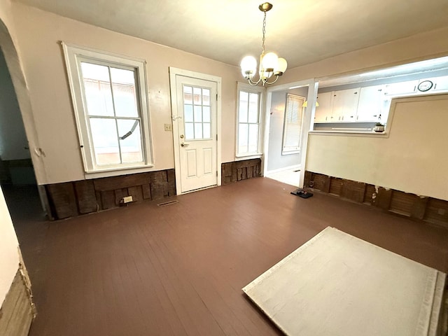 miscellaneous room with hardwood / wood-style flooring and a notable chandelier