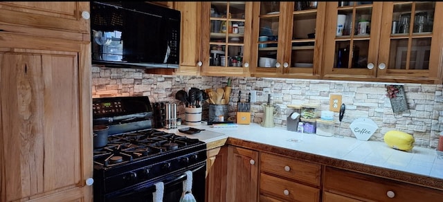 607 N W St, Coudersport, PA 16915 - kitchen featuring black appliances, tasteful backsplash, glass insert cabinets, and light countertops