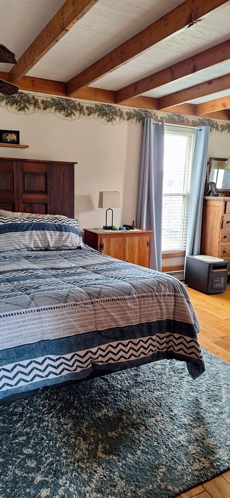 607 N W St, Coudersport, PA 16915 - bedroom with wood finished floors and beamed ceiling