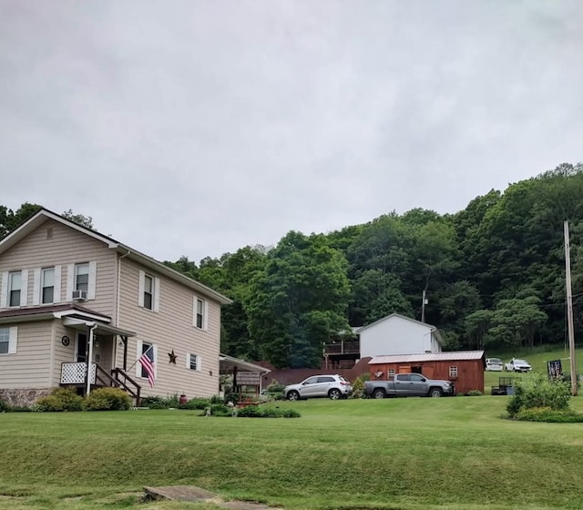 607 N W St, Coudersport, PA 16915 - view of property exterior featuring a lawn and a view of trees